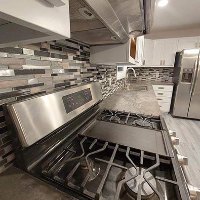 Center State Contracting renovated this kitchen remodel in Central Wisconsin with custom tile backsplash, flooring installation, cabinets and countertops